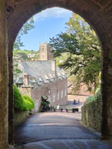 Looking out the gateway with the stables and St George's church in the view